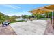 Community patio overlooking a lake with tables, chairs, and shaded seating area at 495 Oak Hill Cir # 44, Sarasota, FL 34232