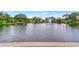Serene view of the pond with a fountain feature and the backs of the neighboring homes at 495 Oak Hill Cir # 44, Sarasota, FL 34232