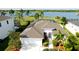 Stunning aerial view of home, featuring a screened pool, waterfront access and lush landscaping at 5078 47Th W St, Bradenton, FL 34210
