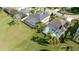 This aerial shot showcases the screened in lanai and pool with lush landscaping and beautiful lawn at 5078 47Th W St, Bradenton, FL 34210