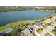 A beautiful aerial view of a home with a pool and lake view and meticulously maintained lawn at 5078 47Th W St, Bradenton, FL 34210