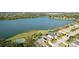 An aerial view of a home's backyard with a private pool and screened-in lanai, adjacent to lush landscaping at 5078 47Th W St, Bradenton, FL 34210