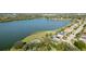 A beautiful aerial view of the home with a pool and lake view and meticulously maintained lawn at 5078 47Th W St, Bradenton, FL 34210