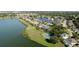 An aerial shot showcasing a lakeside property with a tennis court, manicured lawns, and beautiful landscaping at 5078 47Th W St, Bradenton, FL 34210