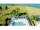 An aerial view of the pool and lanai overlooking the manicured lawn at 5078 47Th W St, Bradenton, FL 34210