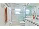 Bright bathroom featuring a shower over tub with glass doors and vanity with a white countertop at 5078 47Th W St, Bradenton, FL 34210