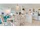 Open dining and kitchen area featuring white cabinetry, stainless steel appliances, and tile flooring at 5078 47Th W St, Bradenton, FL 34210