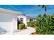Charming single-story home with a two-car garage, walkway, and mature tropical landscaping at 5078 47Th W St, Bradenton, FL 34210