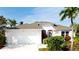 Charming home with a manicured front yard, attached garage, and tropical landscaping at 5078 47Th W St, Bradenton, FL 34210