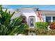 Charming front door featuring tropical landscaping and a decorative screen door at 5078 47Th W St, Bradenton, FL 34210