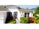 Charming front entrance with decorative door and colorful foliage enhancing curb appeal at 5078 47Th W St, Bradenton, FL 34210
