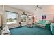 Bright living room featuring blue carpet and decor, with view to the pool at 5078 47Th W St, Bradenton, FL 34210
