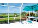 Enclosed patio dining area with table, bar seating, lawn and river view at 5078 47Th W St, Bradenton, FL 34210
