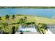 Aerial view of a screened in pool and lush landscaping overlooking a lake at 5078 47Th W St, Bradenton, FL 34210