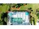 Aerial view of a screened in pool with blue umbrellas surrounded by lush landscaping at 5078 47Th W St, Bradenton, FL 34210