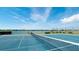 Tennis court featuring a view of the lake with a bench nearby, a place to relax after the game at 5078 47Th W St, Bradenton, FL 34210
