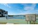 A picturesque community tennis court sits adjacent to a tranquil lake, blending recreation and scenic beauty at 5078 47Th W St, Bradenton, FL 34210