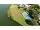 Aerial view of a property with a tennis court and pool in a lakeside community at 5078 47Th W St, Bradenton, FL 34210