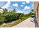Spacious backyard featuring a paved patio, lush landscaping, seating, and a barbecue grill at 5301 Shell Mound Cir, Punta Gorda, FL 33982