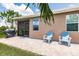 Paved patio with grill and chairs, perfect for outdoor entertainment in this backyard setting at 5301 Shell Mound Cir, Punta Gorda, FL 33982