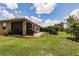 Fenced backyard with patio, grill, seating, and lush lawn providing privacy and space for outdoor living at 5301 Shell Mound Cir, Punta Gorda, FL 33982