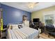 This bedroom has blue and green accent walls, a ceiling fan and space for a desk and entertainment area at 5301 Shell Mound Cir, Punta Gorda, FL 33982