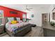 Bedroom featuring a large bed with a gray frame, a red accent wall, and hardwood floors at 5301 Shell Mound Cir, Punta Gorda, FL 33982