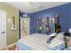 Comfortable bedroom featuring a unique design with instruments decorating the wall and access to the bathroom at 5301 Shell Mound Cir, Punta Gorda, FL 33982