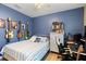 Comfortable bedroom featuring a unique design with instruments decorating the blue wall and a ceiling fan at 5301 Shell Mound Cir, Punta Gorda, FL 33982