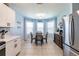 Charming eat-in kitchen area with bright blue walls and a cozy breakfast nook surrounded by natural light at 5301 Shell Mound Cir, Punta Gorda, FL 33982