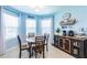 Charming eat-in kitchen area with bright blue walls and a cozy breakfast nook surrounded by natural light at 5301 Shell Mound Cir, Punta Gorda, FL 33982
