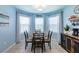 Charming eat-in kitchen area with bright blue walls and a cozy breakfast nook surrounded by natural light at 5301 Shell Mound Cir, Punta Gorda, FL 33982