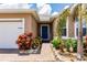 Charming entryway with a brick pathway and colorful landscaping leading to the front door at 5301 Shell Mound Cir, Punta Gorda, FL 33982