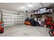 Spacious garage with an overhead storage rack, covered motorcycle and room for storage and tools at 5301 Shell Mound Cir, Punta Gorda, FL 33982