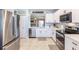 Modern kitchen boasts stainless steel appliances, white cabinetry, and a stylish backsplash for a contemporary feel at 5301 Shell Mound Cir, Punta Gorda, FL 33982