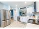 Modern kitchen boasts stainless steel appliances, white cabinetry, and a stylish backsplash for a contemporary feel at 5301 Shell Mound Cir, Punta Gorda, FL 33982