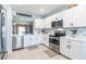 Modern kitchen boasts stainless steel appliances, white cabinetry, and a stylish backsplash for a contemporary feel at 5301 Shell Mound Cir, Punta Gorda, FL 33982
