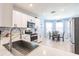 Bright kitchen with stainless steel appliances, white cabinetry and adjacent dining area at 5301 Shell Mound Cir, Punta Gorda, FL 33982