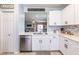 Modern kitchen boasts stainless steel appliances, white cabinetry, and a stylish backsplash for a contemporary feel at 5301 Shell Mound Cir, Punta Gorda, FL 33982