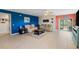 Spacious living room with blue and coral accent walls with tan sofas and tile floors at 5301 Shell Mound Cir, Punta Gorda, FL 33982