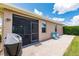 The patio features an outdoor grill, two blue chairs, and view of the landscaped yard at 5301 Shell Mound Cir, Punta Gorda, FL 33982