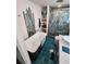 Bright bathroom boasts a modern tub, blue tile floor and backsplash, and a glass shower at 5402 Chateau Ln, Bradenton, FL 34207