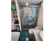 Modern bathroom showcasing a glass shower, stylish fixtures, and turquoise tile floors at 5402 Chateau Ln, Bradenton, FL 34207