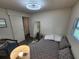 Comfortable bedroom with a double bed, stylish chair, and laminate flooring with natural light at 5402 Chateau Ln, Bradenton, FL 34207