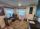Bright dining area features a wood desk, two windows and light wood floors at 5402 Chateau Ln, Bradenton, FL 34207