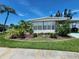 Attractive home featuring a well-manicured lawn, lush landscaping, and mature tropical foliage at 5402 Chateau Ln, Bradenton, FL 34207