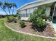 Charming home with a beautiful landscaped front yard, healthy green grass, and lovely flowering plants at 5402 Chateau Ln, Bradenton, FL 34207