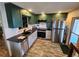 Modern kitchen with stainless steel appliances, sleek countertops, and two-toned cabinets at 5402 Chateau Ln, Bradenton, FL 34207