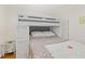 Cozy bedroom features a white bunk bed with gray headboard and colorful bedding at 6016 Hibiscus Dr, Bradenton, FL 34207
