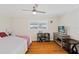 Bright bedroom featuring a ceiling fan and hardwood floors, providing a restful retreat at 6016 Hibiscus Dr, Bradenton, FL 34207